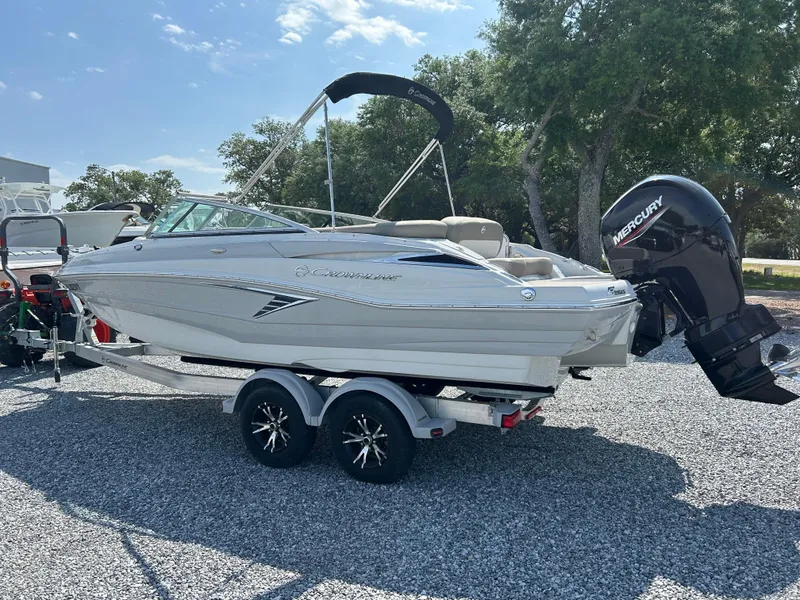 Slide: The Image of 2021 Crownline Eclipse E215 XS boat on trailer, featuring a Mercury outboard motor. - 5