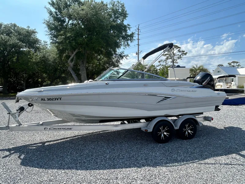 Slide: The Image of 2021 Crownline Eclipse E215 XS boat on trailer, parked outdoors. - 6