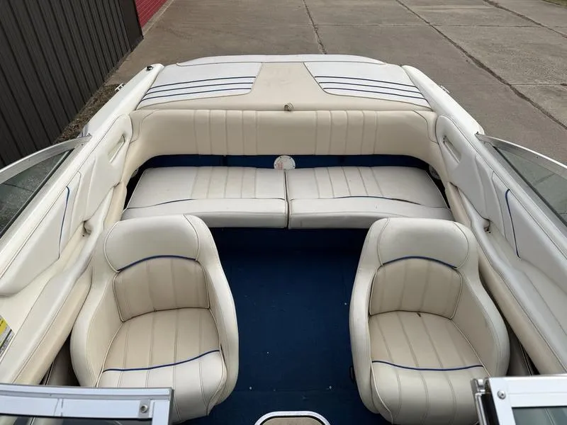 Slide: The Image of 1996 Sea Ray 210 Signature boat interior with white seating and blue carpet. - 10