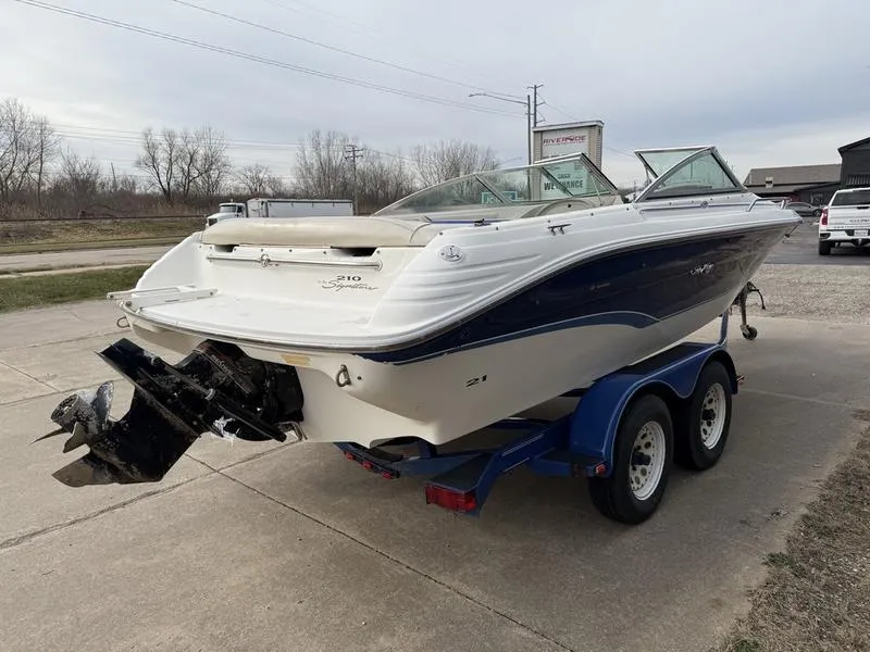 Slide: The Image of 1996 Sea Ray 210 Signature boat on trailer, parked outdoors. - 5
