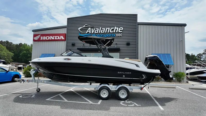 Slide: The Image of 2025 Bayliner VR6 boat on trailer at Avalanche Motorsports dealership. - 1