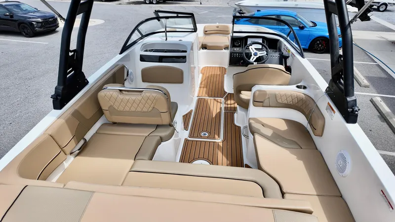 Slide: The Image of 2025 Bayliner VR6 boat interior with beige seating and wood accents. - 12