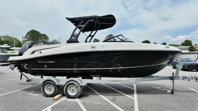 Slide: The Image of 2025 Bayliner VR6 boat on trailer, black and white design, parked outdoors. - 15