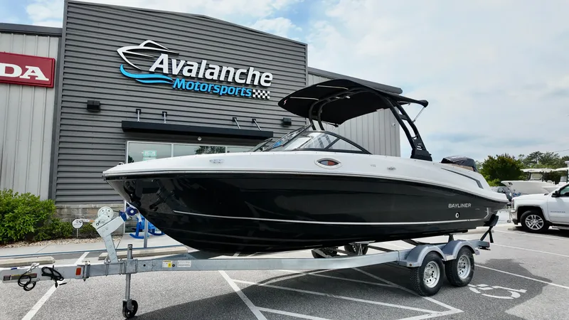 Slide: The Image of 2025 Bayliner VR6 boat on trailer at Avalanche Motorsports dealership. - 2