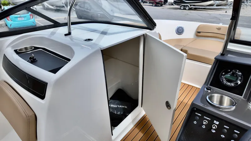 Slide: The Image of 2025 Bayliner VR6 boat interior with open storage, modern dashboard, and seating area. - 3