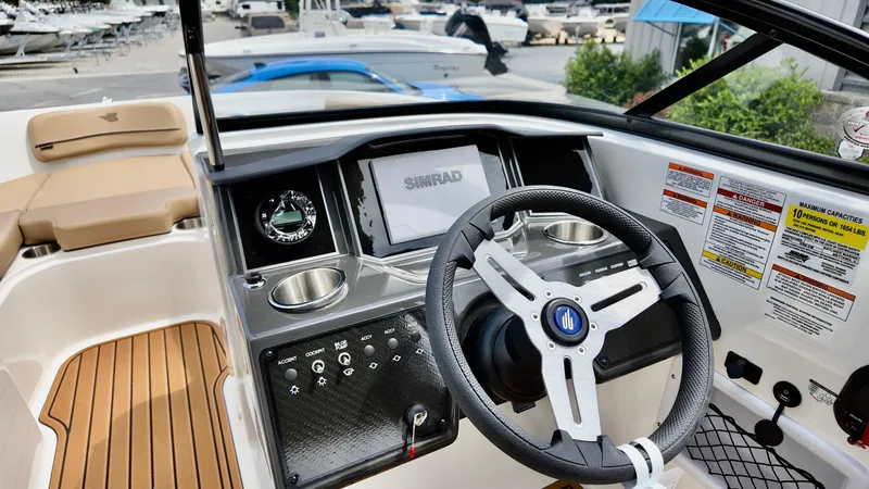 Slide: The Image of 2025 Bayliner VR6 boat dashboard with steering wheel and navigation system. - 4