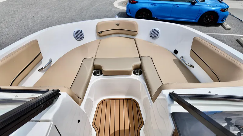 Slide: The Image of 2025 Bayliner VR6 boat interior with tan seating and wood accents. - 9
