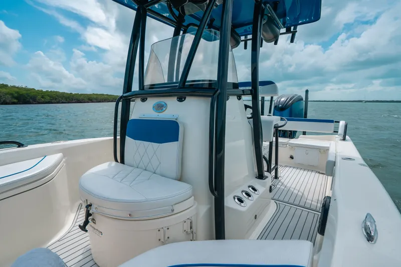 Slide: The Image of 2015 Hydra-Sports 23 Bay boat interior with seating, console, and ocean view. - 11