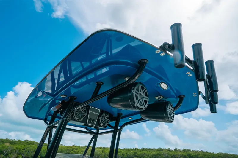 Slide: The Image of 2015 Hydra-Sports 23 Bay boat with blue T-top and mounted speakers. - 12