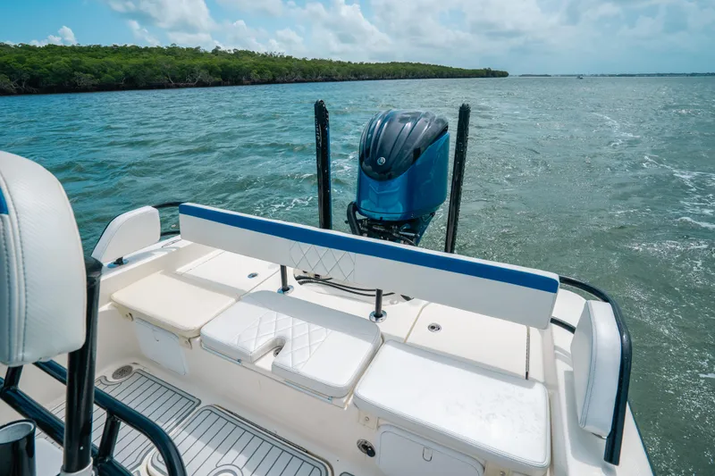 Slide: The Image of 2015 Hydra-Sports 23 Bay boat on water, featuring rear seating and outboard motor. - 16