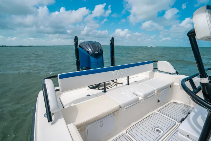 Slide: The Image of 2015 Hydra-Sports 23 Bay boat on open water under a cloudy sky. - 17