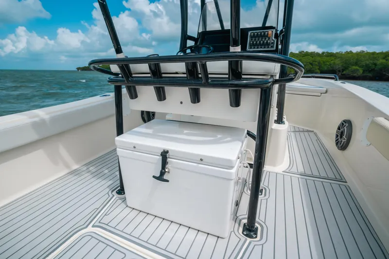 Slide: The Image of 2015 Hydra-Sports 23 Bay boat interior with cooler and console, on calm waters. - 19