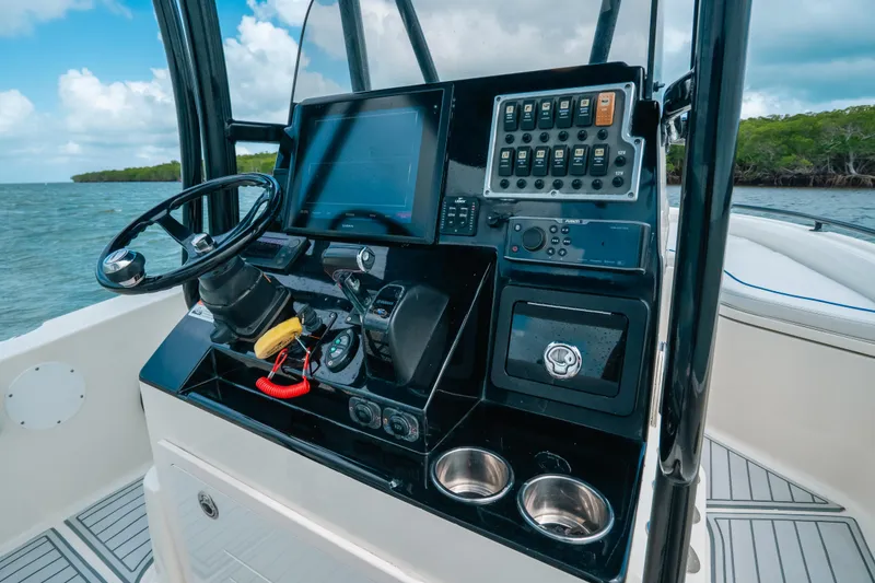 Slide: The Image of 2015 Hydra-Sports 23 Bay boat console with steering wheel and navigation controls. - 26
