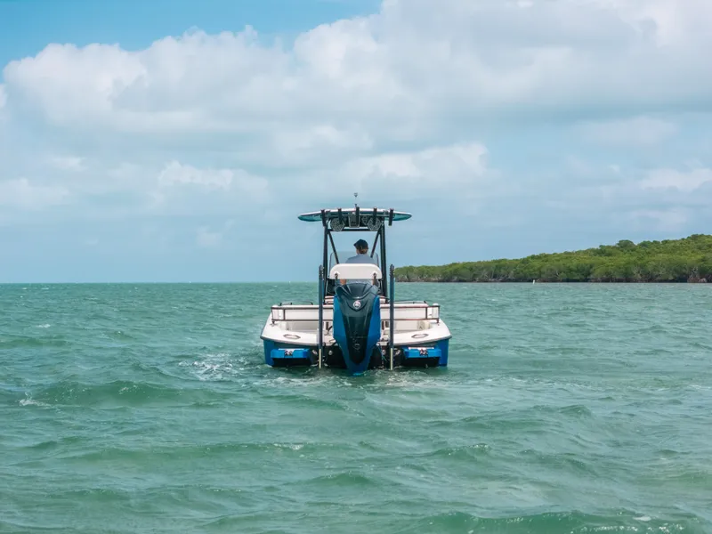 Slide: The Image of 2015 Hydra-Sports 23 Bay boat cruising on open water under a cloudy sky. - 33