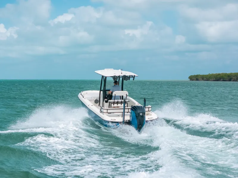 Slide: The Image of 2015 Hydra-Sports 23 Bay boat cruising on open water under a cloudy sky. - 37