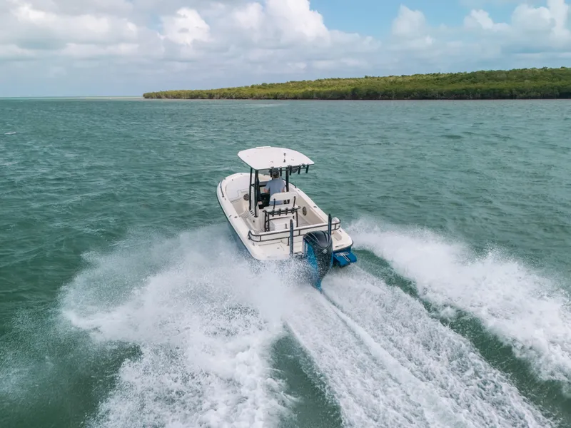 Slide: The Image of 2015 Hydra-Sports 23 Bay boat cruising on open water, creating a wake. - 38