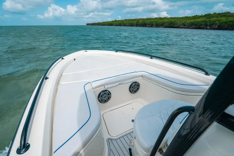 Slide: The Image of 2015 Hydra-Sports 23 Bay boat on calm waters with lush shoreline. - 6