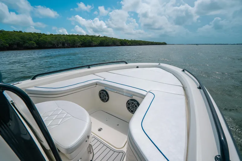 Slide: The Image of 2015 Hydra-Sports 23 Bay boat interior with seating, on a scenic waterway. - 7