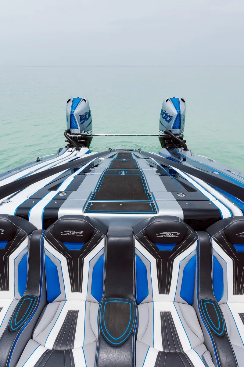Slide: The Image of 2024 MTI 440X powerboat with sleek design and dual engines on calm water. - 31