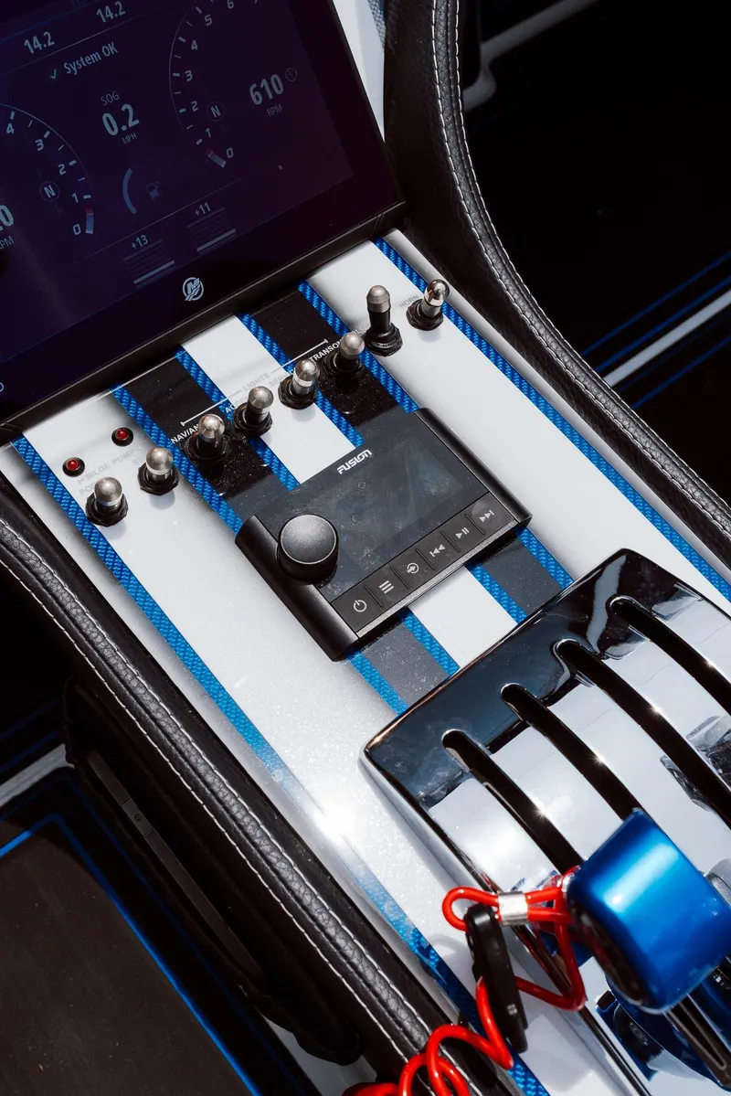 Slide: The Image of Control panel of 2024 MTI 440X boat with switches and display screen. - 44