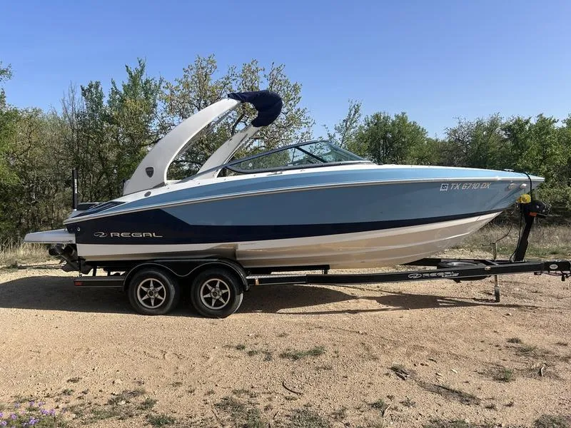 Slide: The Image of 2017 Regal 2300 Bowrider boat on trailer, parked outdoors. - 0