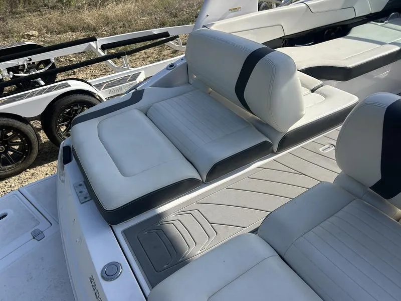 Slide: The Image of 2017 Regal 2300 Bowrider boat interior with white seating and gray flooring. - 10