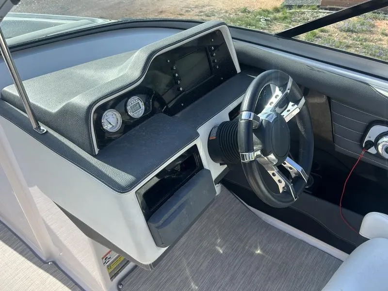 Slide: The Image of 2017 Regal 2300 Bowrider dashboard with steering wheel and gauges. - 2