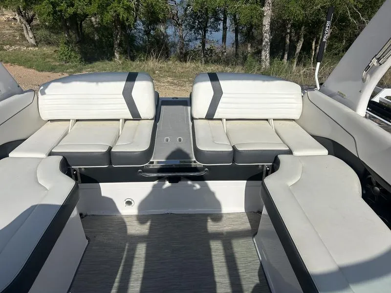 Slide: The Image of 2017 Regal 2300 Bowrider interior with white seating, outdoor setting in background. - 4