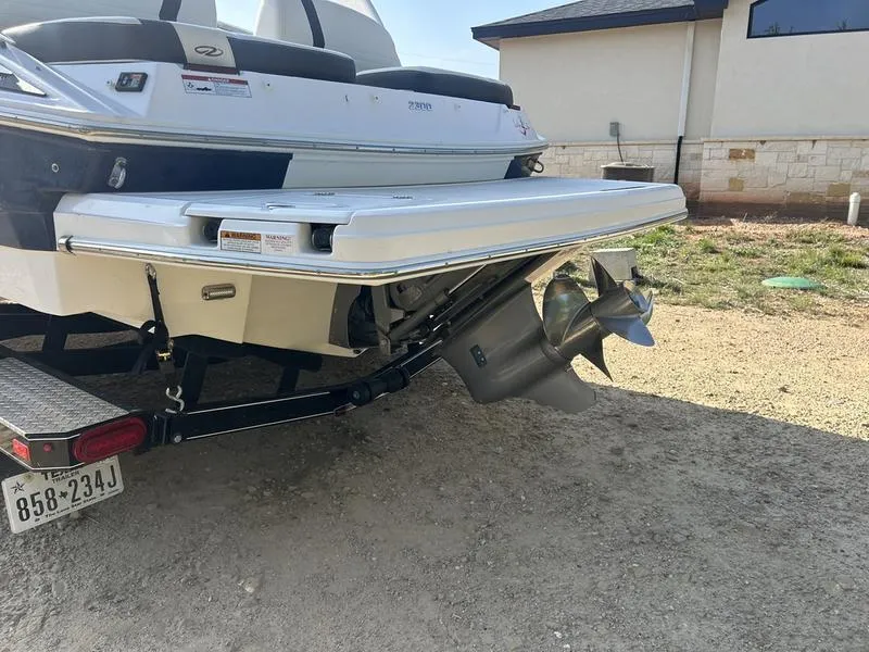 Slide: The Image of 2017 Regal 2300 Bowrider boat on trailer, rear view with propeller visible. - 5