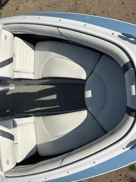 Slide: The Image of 2017 Regal 2300 Bowrider boat interior with white cushioned seating. - 7