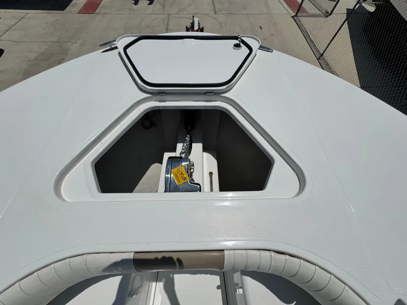 Slide: The Image of 2015 Southport 29 FE boat anchor compartment, open hatch, docked on concrete surface. - 10