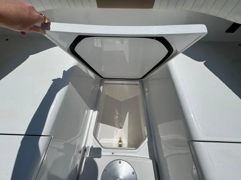 Slide: The Image of 2015 Southport 29 FE boat storage compartment open, showcasing spacious interior design. - 11