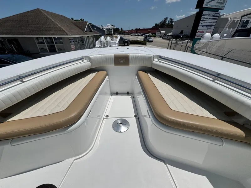 Slide: The Image of 2015 Southport 29 FE boat interior with tan and white seating. - 12