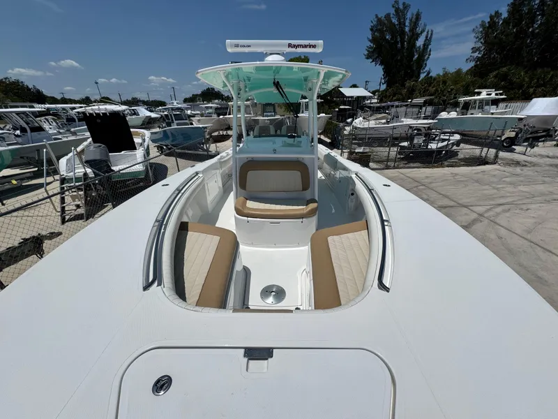 Slide: The Image of 2015 Southport 29 FE boat with spacious deck and seating, docked under clear skies. - 13