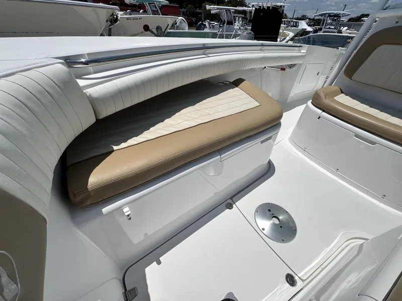 Slide: The Image of 2015 Southport 29 FE boat interior with cushioned seating and sleek design. - 14