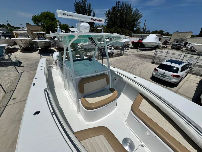 Slide: The Image of 2015 Southport 29 FE boat with tan seating, docked in a marina. - 17