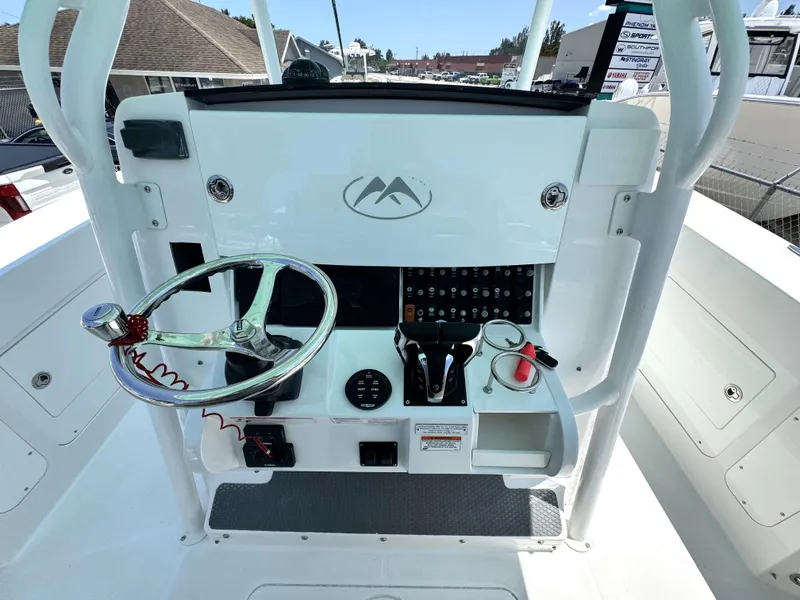 Slide: The Image of 2015 Southport 29 FE boat helm with steering wheel and control panel. - 23