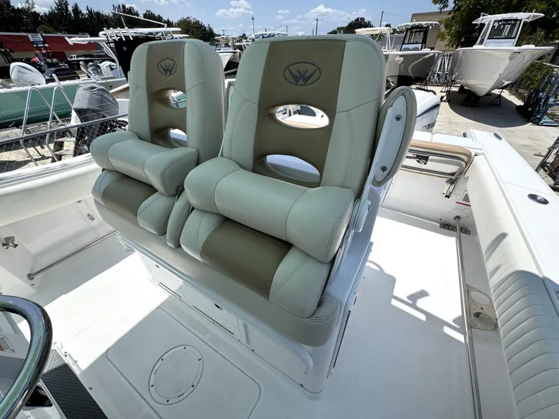 Slide: The Image of 2015 Southport 29 FE boat with dual cushioned seats, docked outdoors. - 27
