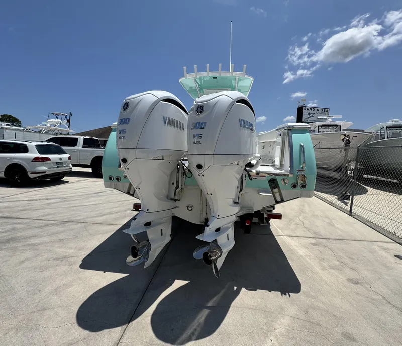 Slide: The Image of 2015 Southport 29 FE boat with twin Yamaha outboard engines in a marina. - 3