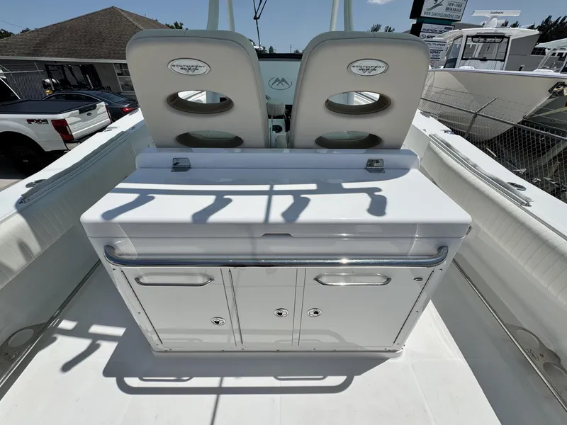 Slide: The Image of 2015 Southport 29 FE boat interior with dual seats and storage console. - 30