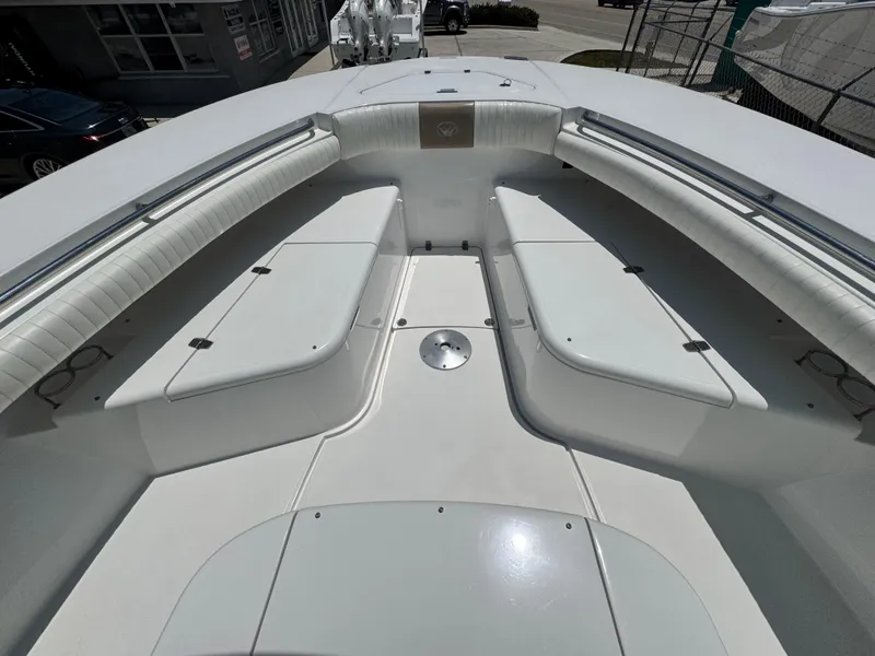 Slide: The Image of 2015 Southport 29 FE boat interior with white seating and spacious deck. - 8