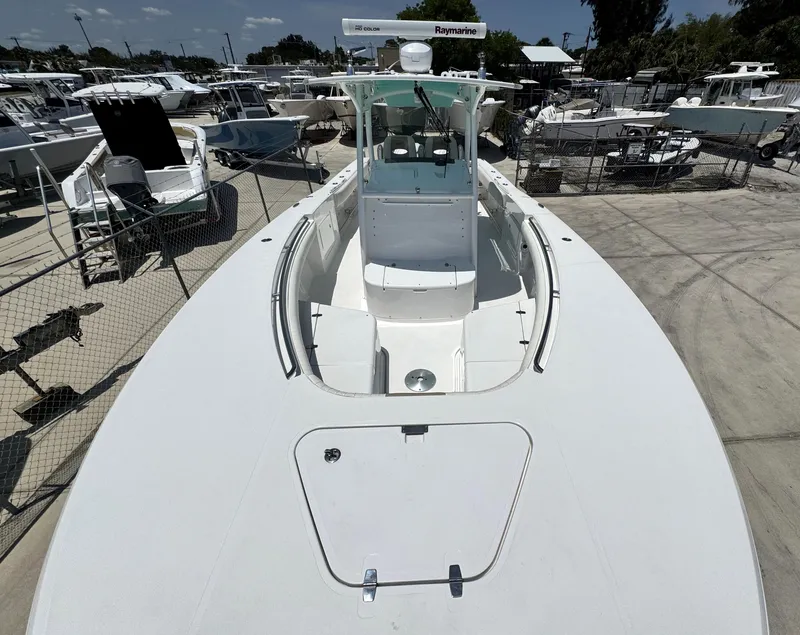 Slide: The Image of 2015 Southport 29 FE boat docked in a marina, surrounded by other vessels. - 9