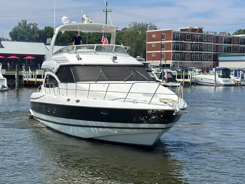 Slide: The Image of 2003 Cruisers Yachts 5000 Sport Sedan in marina, featuring sleek design and modern amenities. - 1