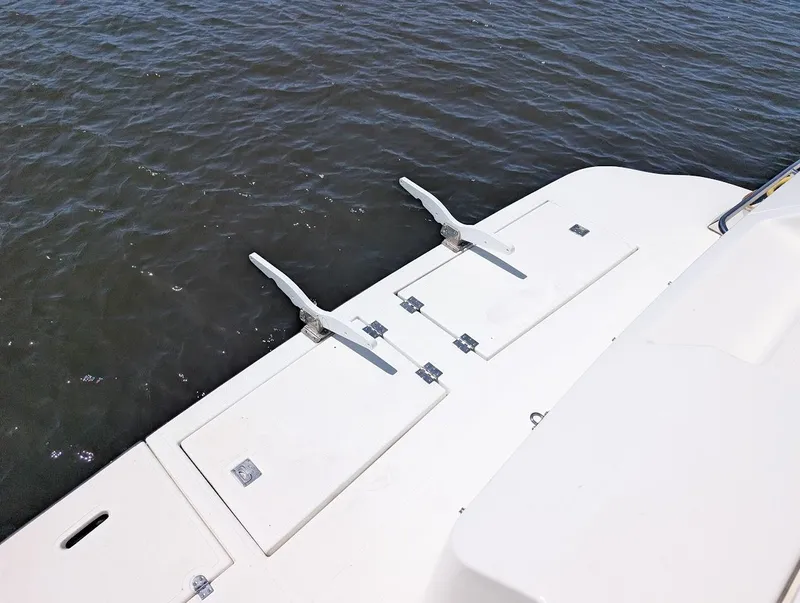 Slide: The Image of 2003 Cruisers Yachts 5000 Sport Sedan swim platform with cleats, docked on calm water. - 10