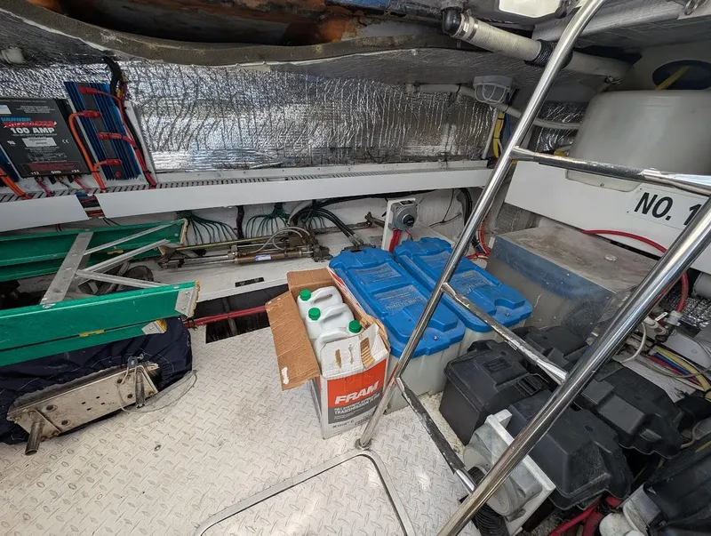 Slide: The Image of Engine room of 2003 Cruisers Yachts 5000 Sport Sedan with equipment and storage items. - 17