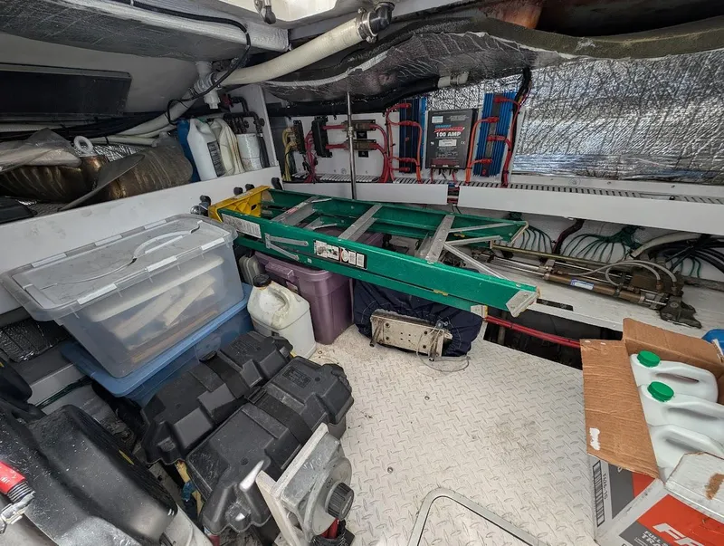 Slide: The Image of Engine room of 2003 Cruisers Yachts 5000 Sport Sedan with tools and equipment. - 18