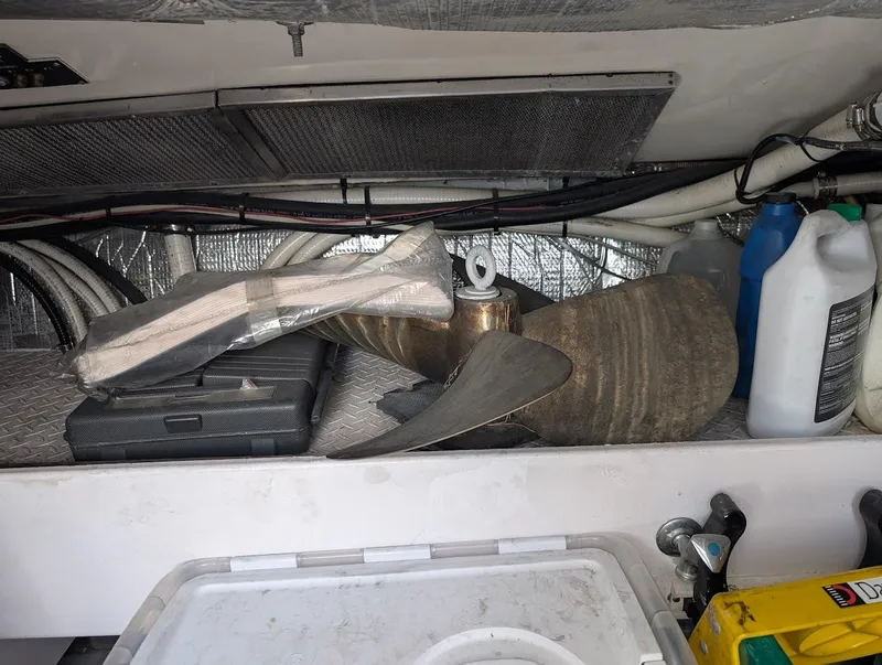 Slide: The Image of Storage compartment of a 2003 Cruisers Yachts 5000 Sport Sedan with propeller and supplies. - 19