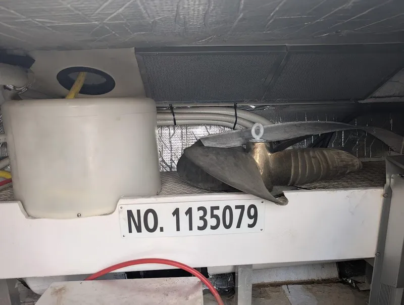 Slide: The Image of 2003 Cruisers Yachts 5000 Sport Sedan engine room with propeller and tank, labeled No. 1135079. - 20