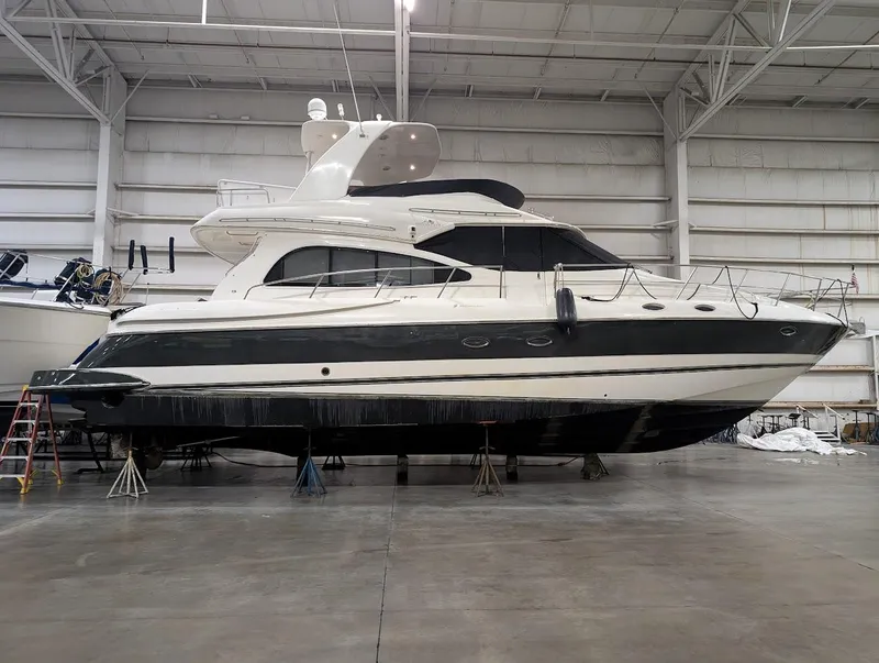 Slide: The Image of 2003 Cruisers Yachts 5000 Sport Sedan in indoor storage, side view. - 33