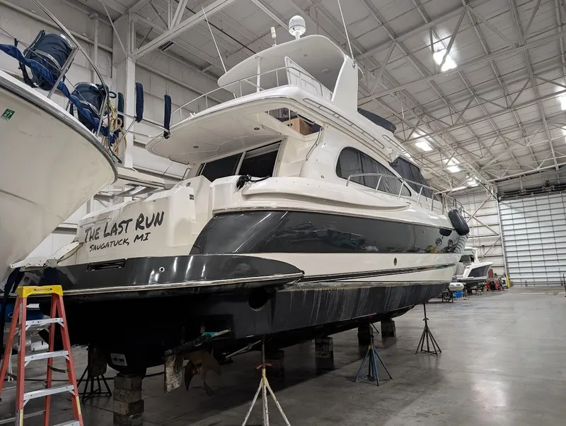 Slide: The Image of 2003 Cruisers Yachts 5000 Sport Sedan in a spacious indoor marina. - 34